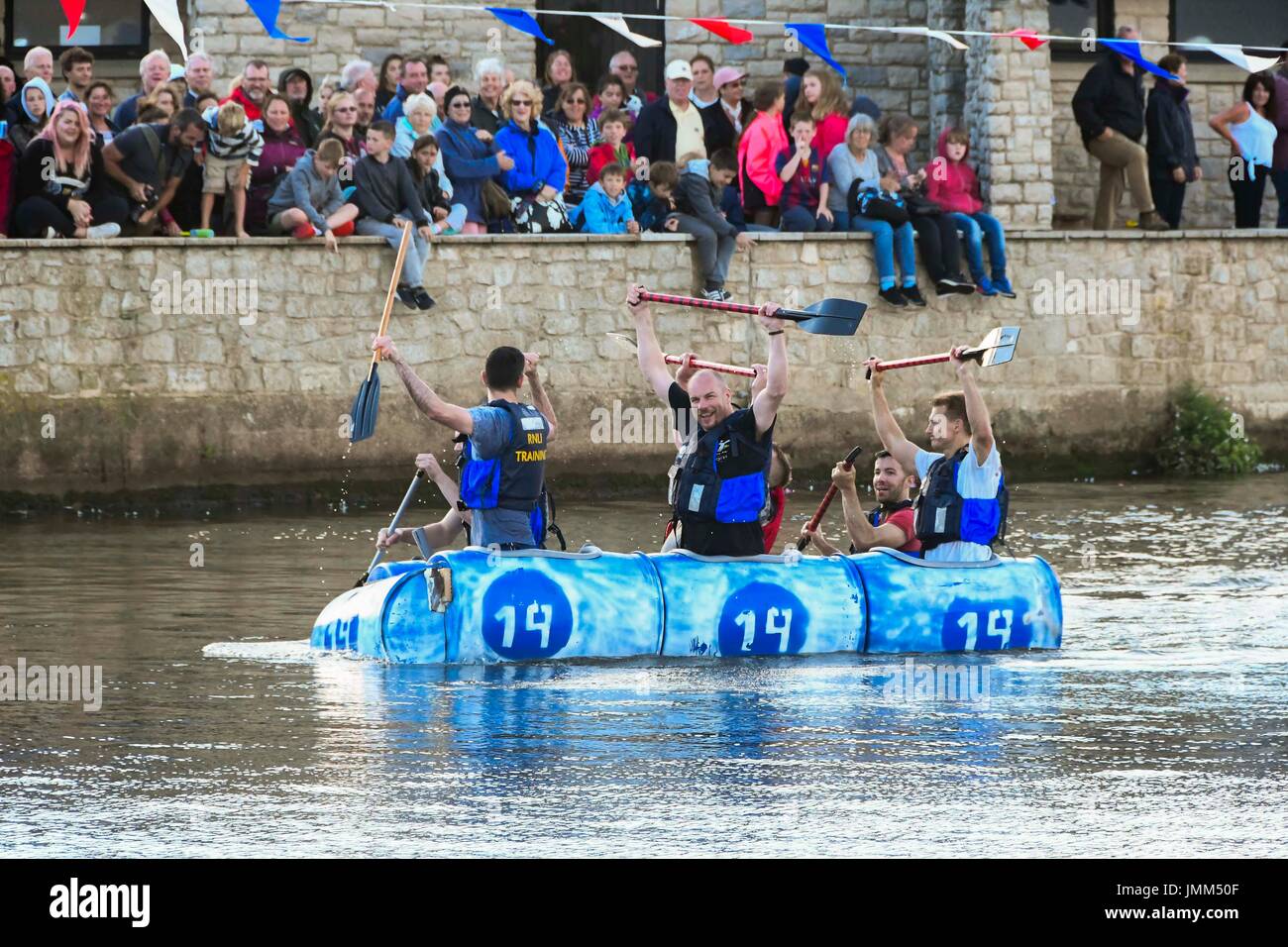 West Bay, Dorset, UK.  27th July 2017.  Annual RNLI Raft Race on the River Brit at the seaside resort of  West Bay in Dorset.  The winning team celebrate victory.  Picture Credit: Graham Hunt/Alamy Live News Stock Photo