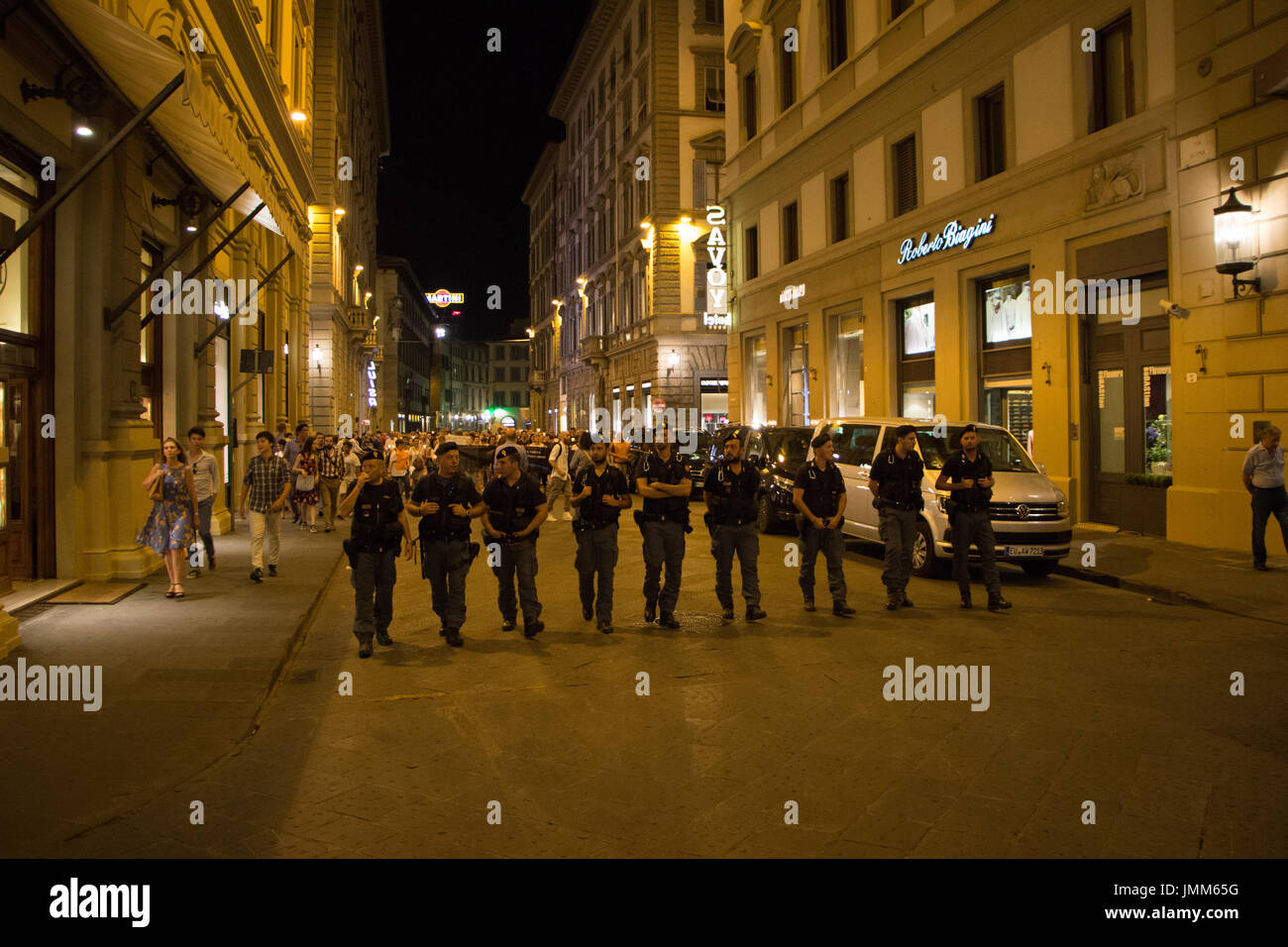 Florence, Italy. 27th July, 2017. Italian police walk to control protesters in Florence Italy who march against a new law introduced by the government which mandates vaccinations for school-children. Credit: Joseph Suschitzky/Alamy Live News Stock Photo