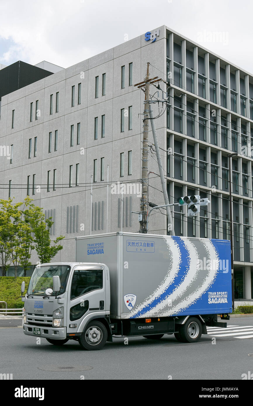 A Sagawa Express delivery truck drives past the Sagawa headquarters on July 28, 2017, Tokyo, Japan. Sagawa Express Co. expects to increase its delivery charges from November 21st due to the increasing demand from online shopping. The company said on Wednesday that its door to door service fee would rise 17.8 percent on average. Competitor Yamato Transport Co. also plans to raise rates in October. Credit: Rodrigo Reyes Marin/AFLO/Alamy Live News Stock Photo