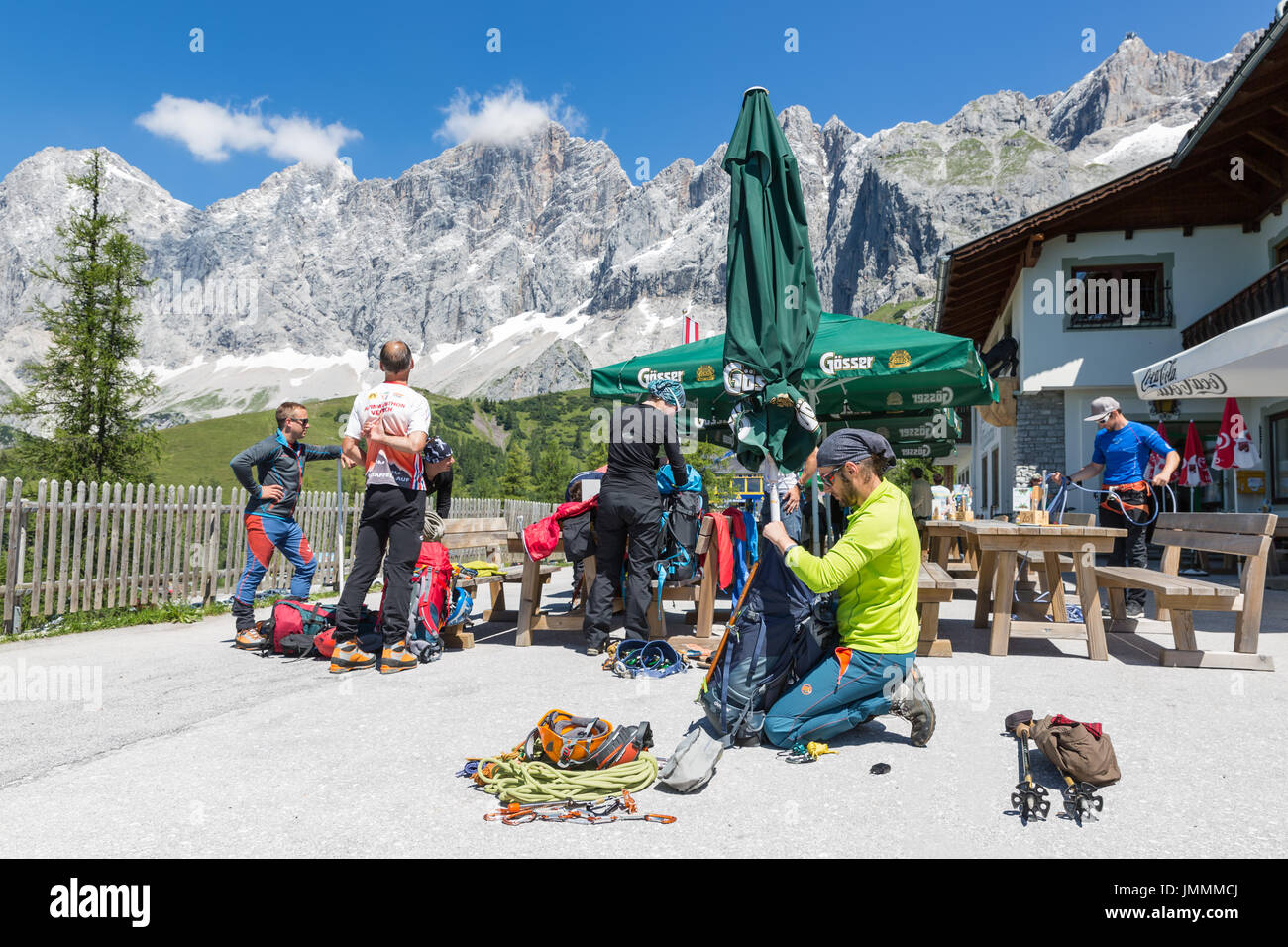 DACHSTEIN MOUNTAINS,  AUSTRIA - JULY 17, 2017: Alpinists preparing their equipment for rock-climbing in Dachstein Mountains of Austria Stock Photo