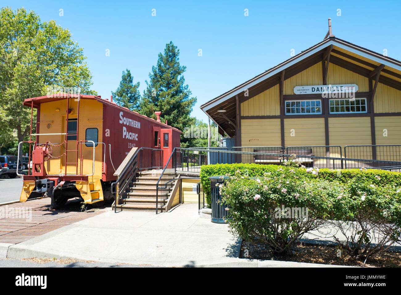 A Southern Pacific railroad caboose is parked on a short section of track outside the Museum of the San Ramon Valley, housed in a historical structure which used to serve as the rail depot for the city of Danville, California, June 27, 2017. Stock Photo