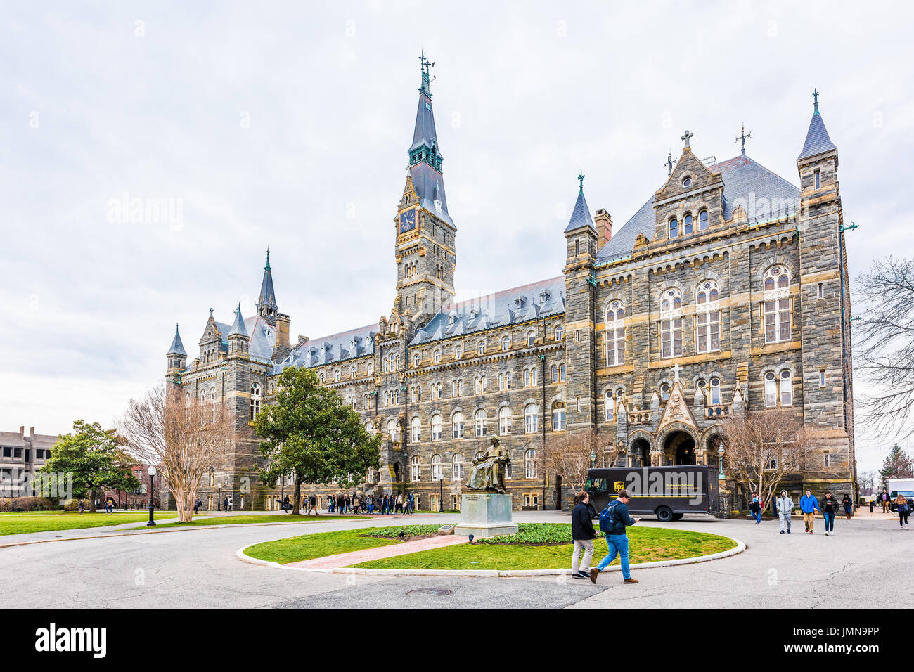 Washington DC, USA - March 20, 2017: Georgetown University on campus with Healy Hall and people walking out of main building Stock Photo