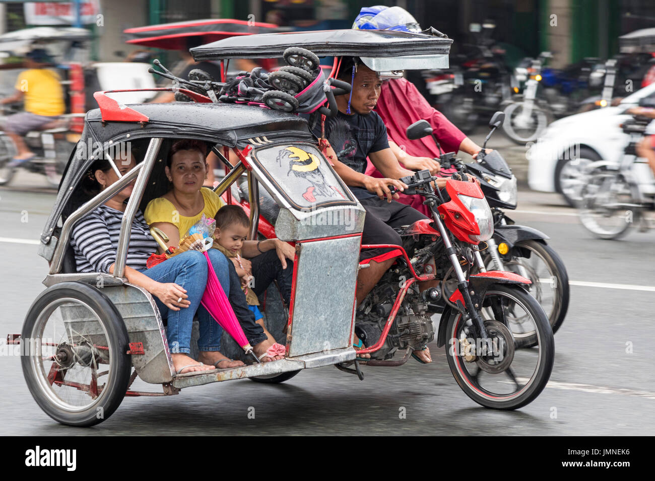 Tricycle taxi in traffic, Angeles City, Pampanga, Philippines Stock Photo