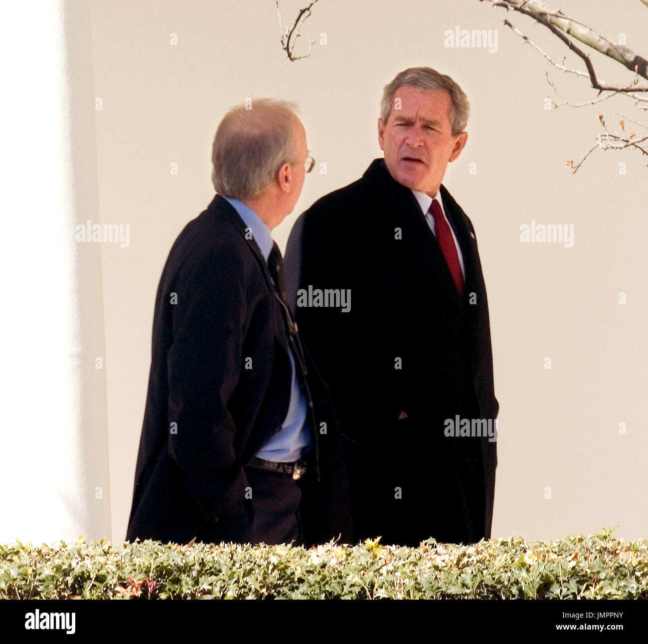 Washington, D.C. - February 28, 2006 -- United States President George W. Bush walks along the Colonnade from the Oval Office to the residence of the White House with Karl Rove, his senior advisor, chief political strategist, and Deputy White House Chief of Staff in charge of policy on February 28, 2006.  The President left the White House a few minutes later aboard Marine 1 for his 5 day trip to India and Pakistan. Credit: Ron Sachs / CNP Stock Photo