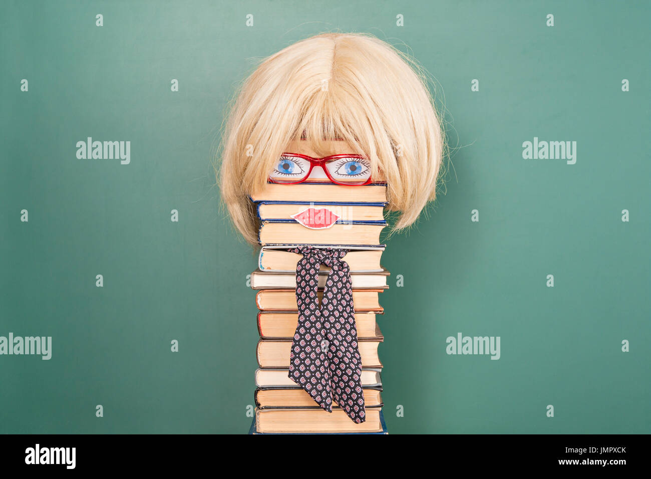 Funny education idea, woman teacher in front of blackboard with copy space Stock Photo