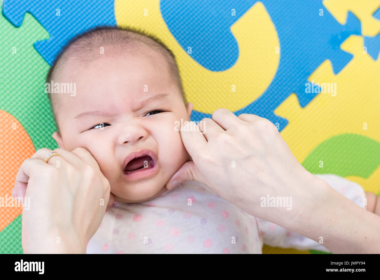 Parent Pinch The Cheeks A Little Adorable Newborn Infant Baby Girl That Lying On The Back On Colorful Eva Foam Indoors Stock Photo Alamy Parent Pinch The Cheeks A Little Adorable Newborn Infant Baby Girl That Lying On The Back On Colorful Eva Foam Indoors Stock Photo Alamy