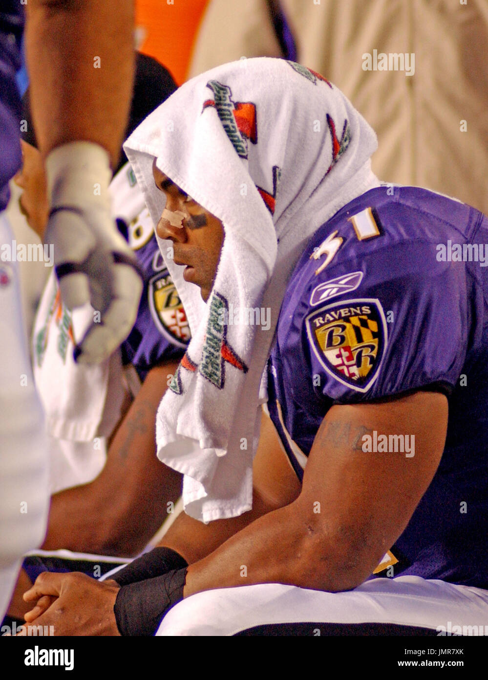 Baltimore Ravens running back Jamal Lewis (31) breaks a tackle attempt by  Cleveland Browns defensive lineman Tyrone Rogers, left, in the first  quarter Sunday, Nov. 7, 2004, in Baltimore. Lewis returned to