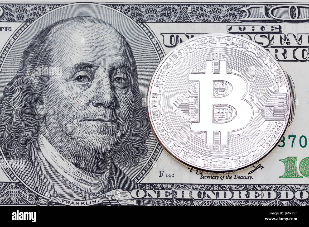Bitcoin coin on one hundred dollar banknotes from united states of america.  Digital crypto currency and US dollar currency. Gold shining coins on pile  Stock Photo - Alamy
