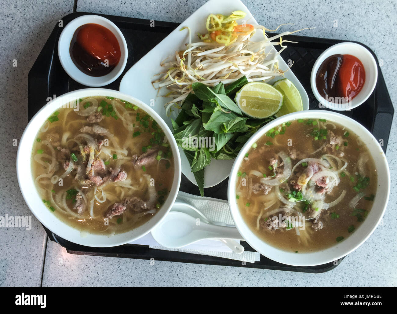 Bowl of Vietnamese pho noodle soup with rare beef, tendon, tripe and
