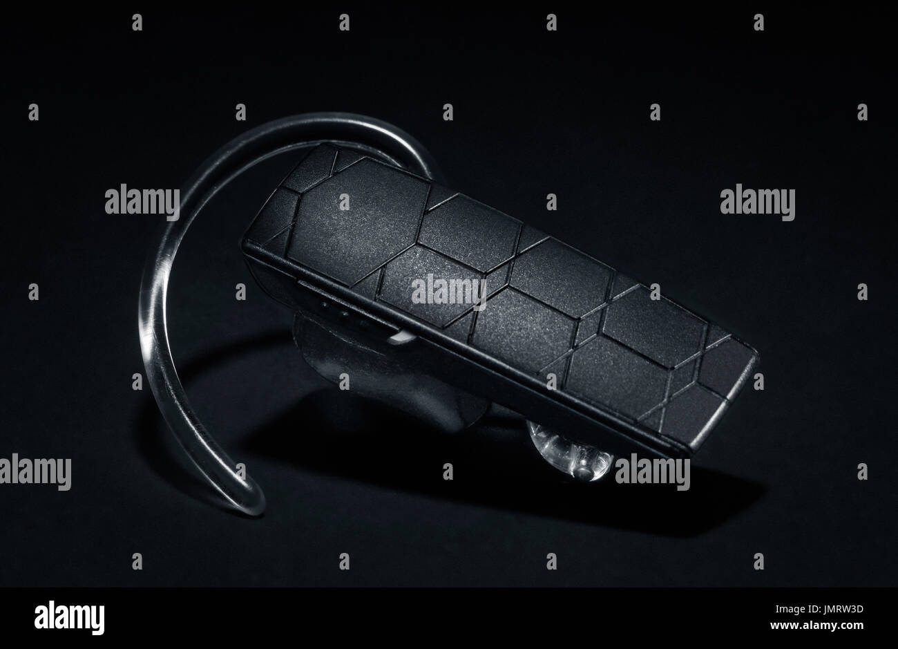 Bluetooth Headset on black background Stock Photo - Alamy