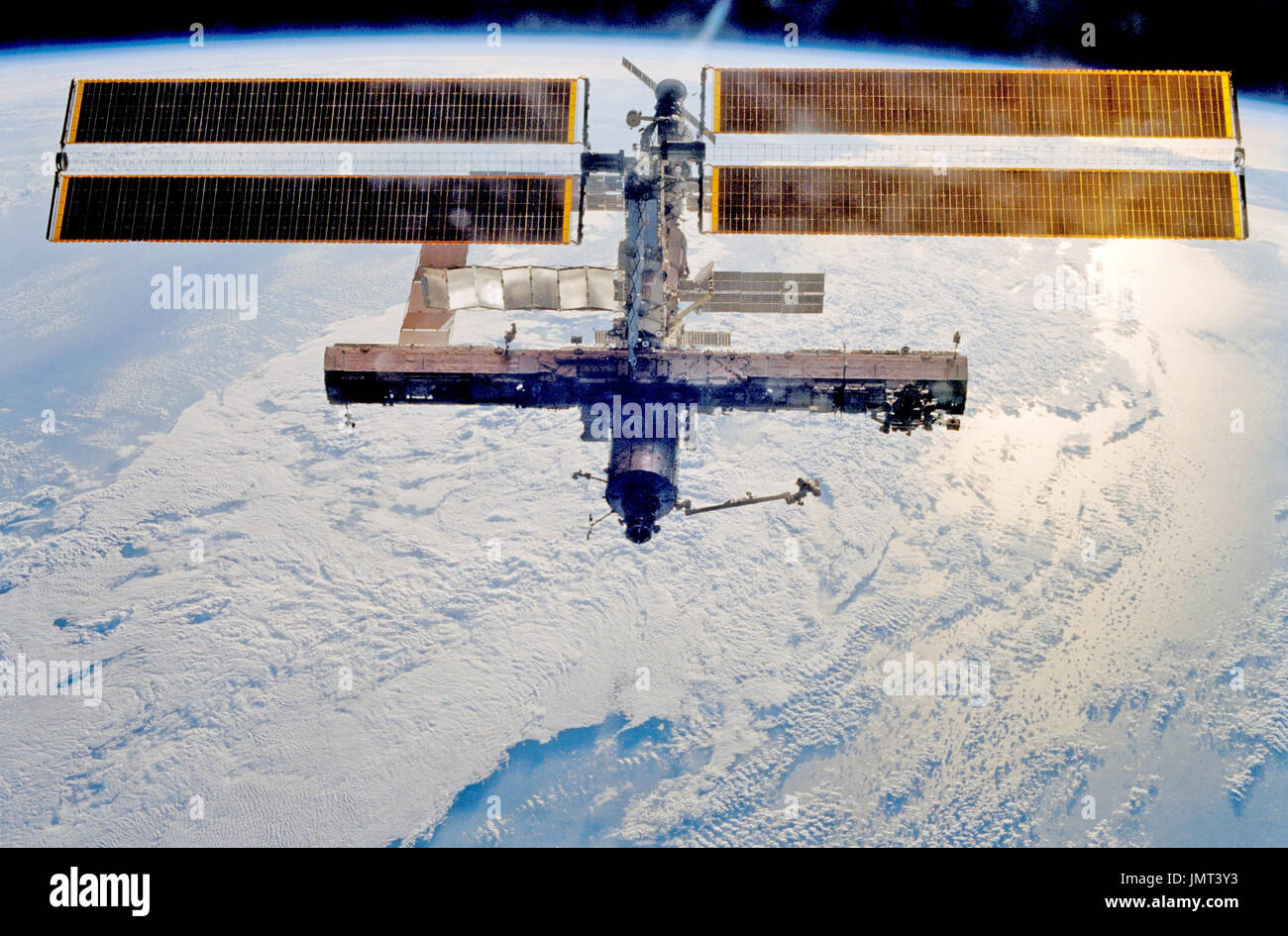 Backdropped by a blue and white Earth, this full view of the ...