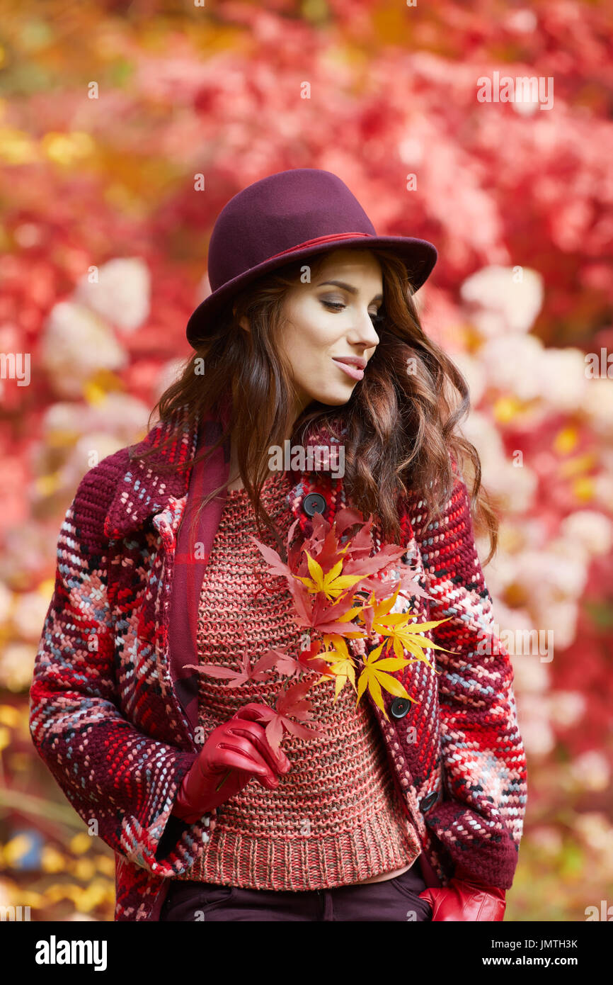 Portrait of an autumn woman over red and golden leaves Stock Photo - Alamy