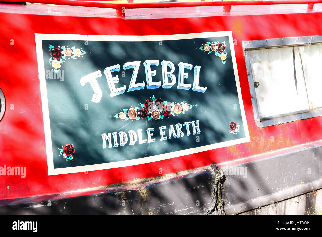 An ornate painted name board on a narrow boat or canal barge called 'Jezebel' from 'middle earth' Stock Photo