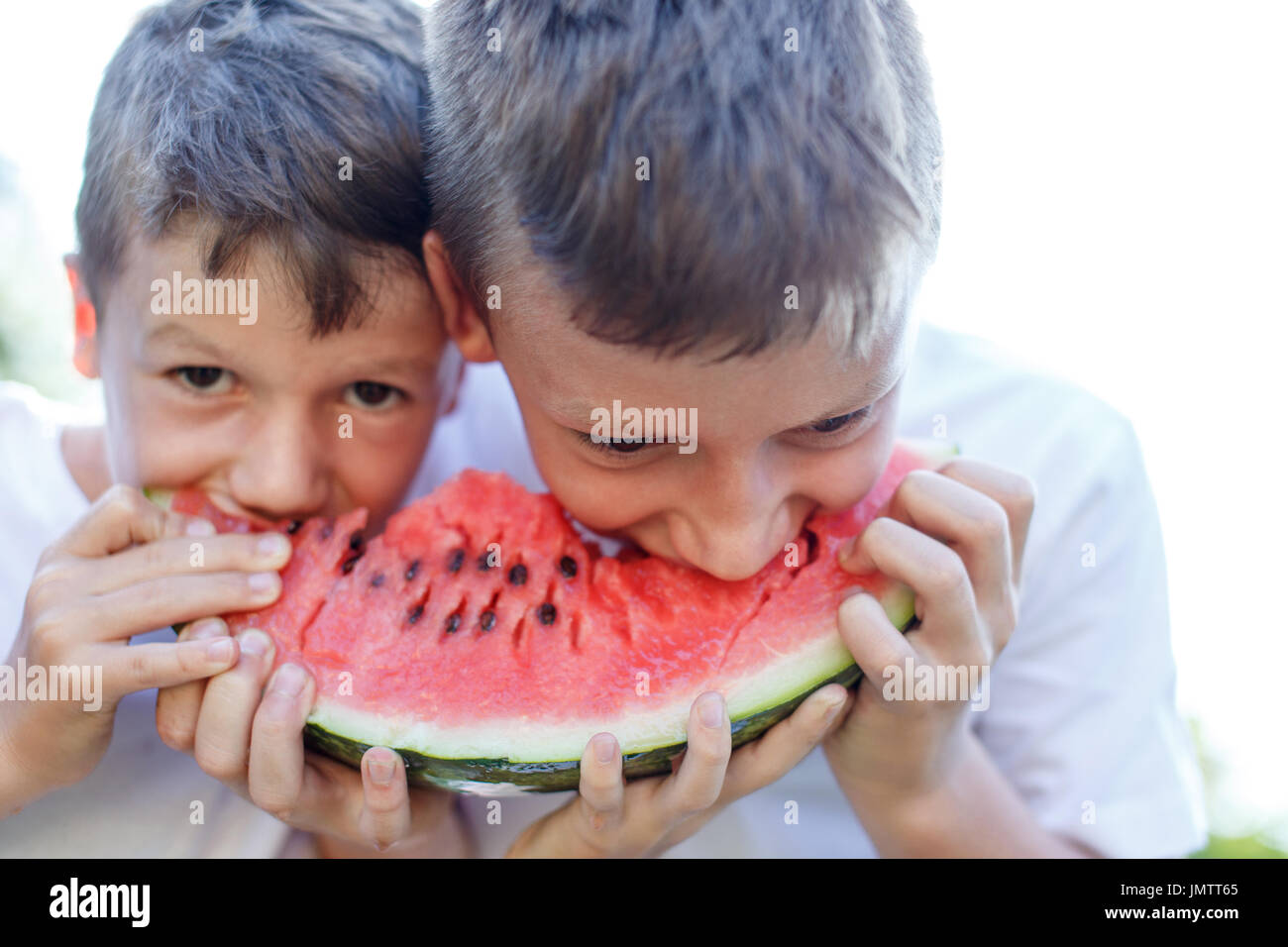 Little caucasian kids eating watermelon outdoor Stock Photo