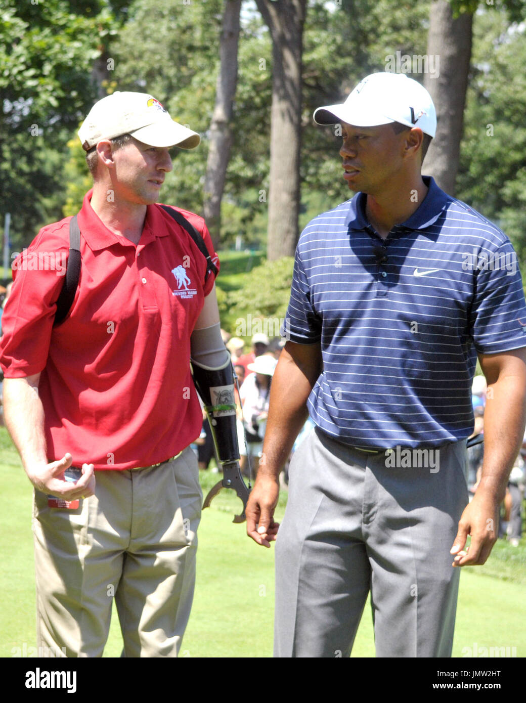 Bethesda, MD - July 1, 2009 -- Tiger Woods, right, shares some thoughts with United States Army Major Ken Dwyer, left, following their ceremonial tee shot to open the AT&T National Hosted by Tiger Woods at Congressional Country Club in Bethesda, Maryland on Wednesday, July 1, 2009. Credit: Ron Sachs / CNP Stock Photo