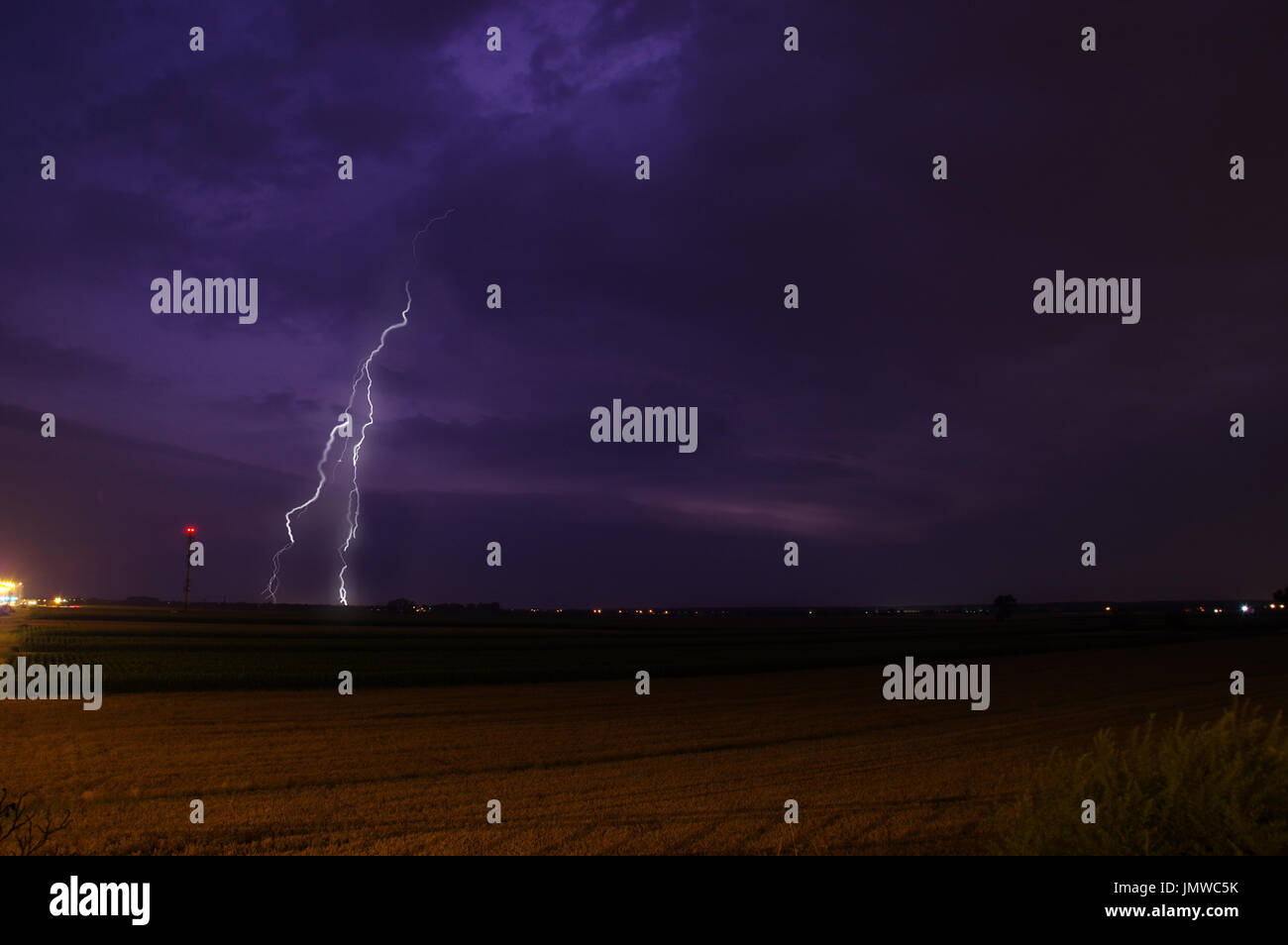 Lightning on heavy and dark clouds. Storm sky. Stock Photo
