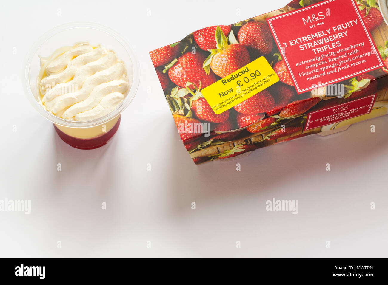 pack of M&S 3 extremely fruity strawberry trifles with one removed set on white background Stock Photo