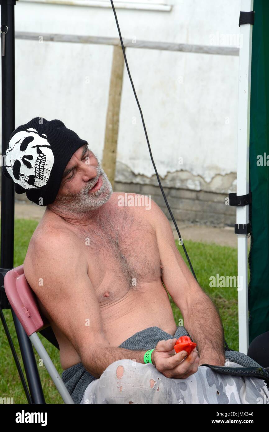 male contestant eating a Chilli at a Chilli Festival Gower chilli Feastival Glamorgan Wales Cymru UK GB Stock Photo