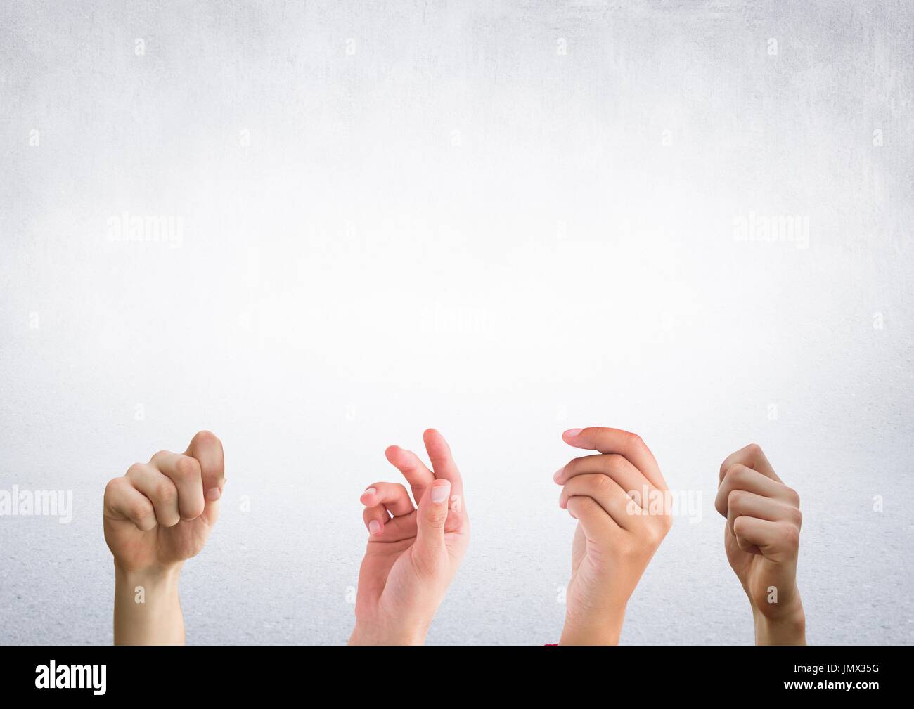 Digital composite of Four hands with bright background Stock Photo
