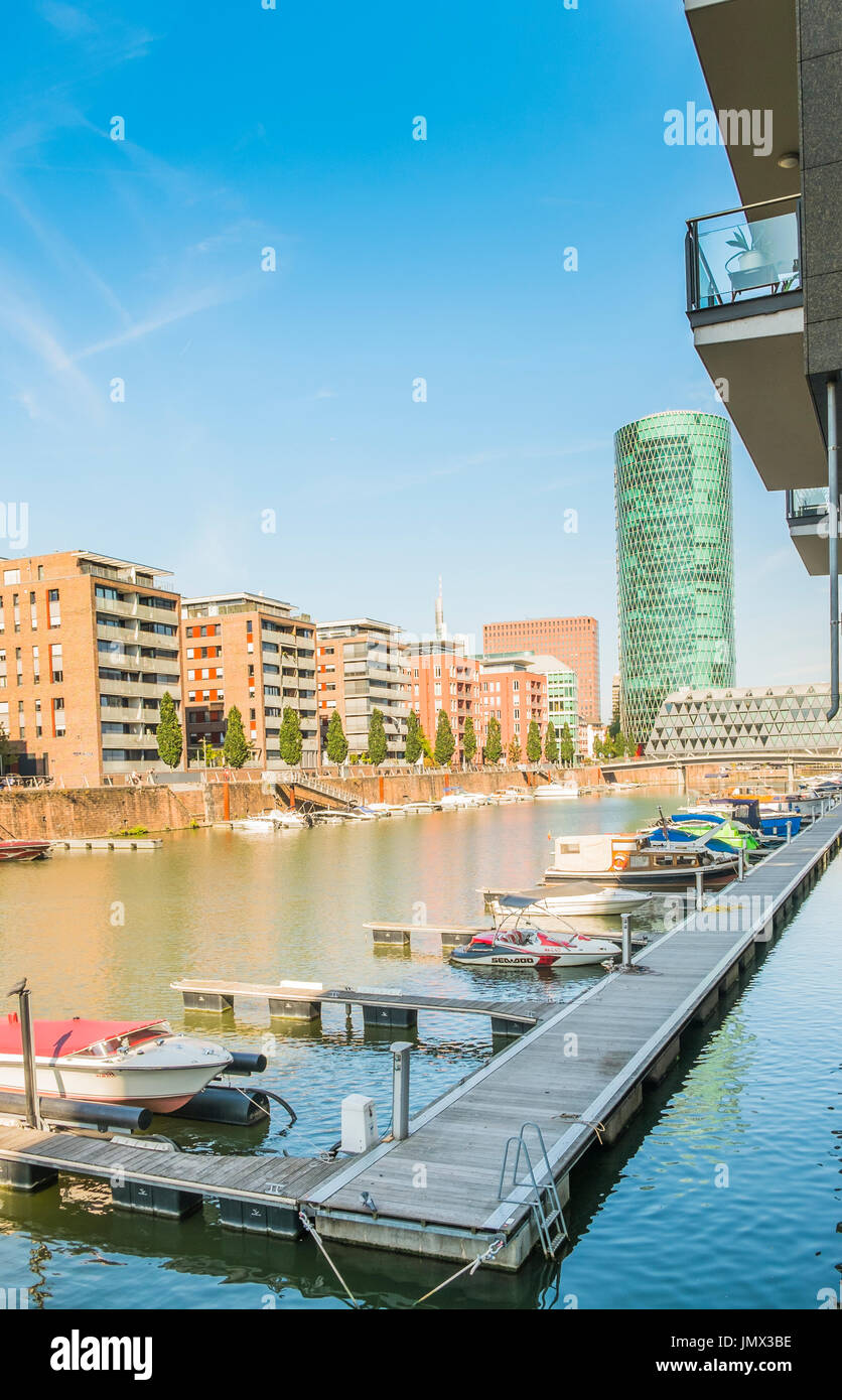 new westhafen residential buildings with westhafen tower in background, moorings and pleasure boats, frankfurt am main, hesse, germany Stock Photo