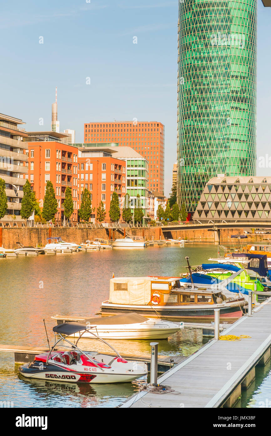 new westhafen residential buildings with westhafen tower in background, moorings and pleasure boats, frankfurt am main, hesse, germany Stock Photo