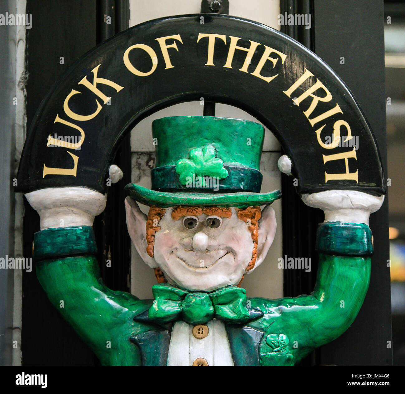 Luck of the Irish figurine in front of a pub. Stock Photo