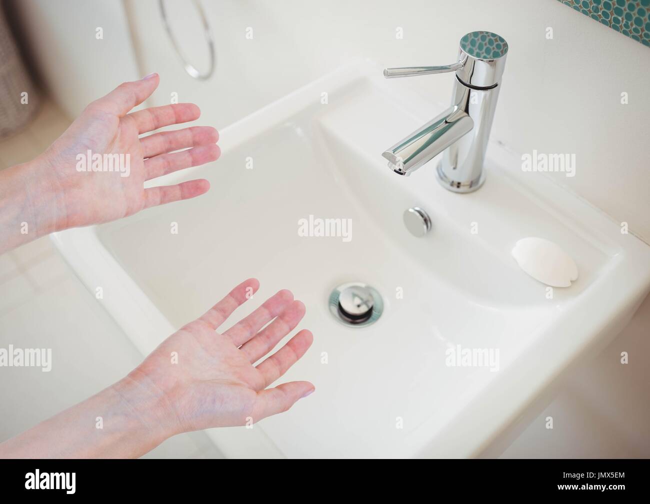 Digital composite of Washing hands in sink Stock Photo