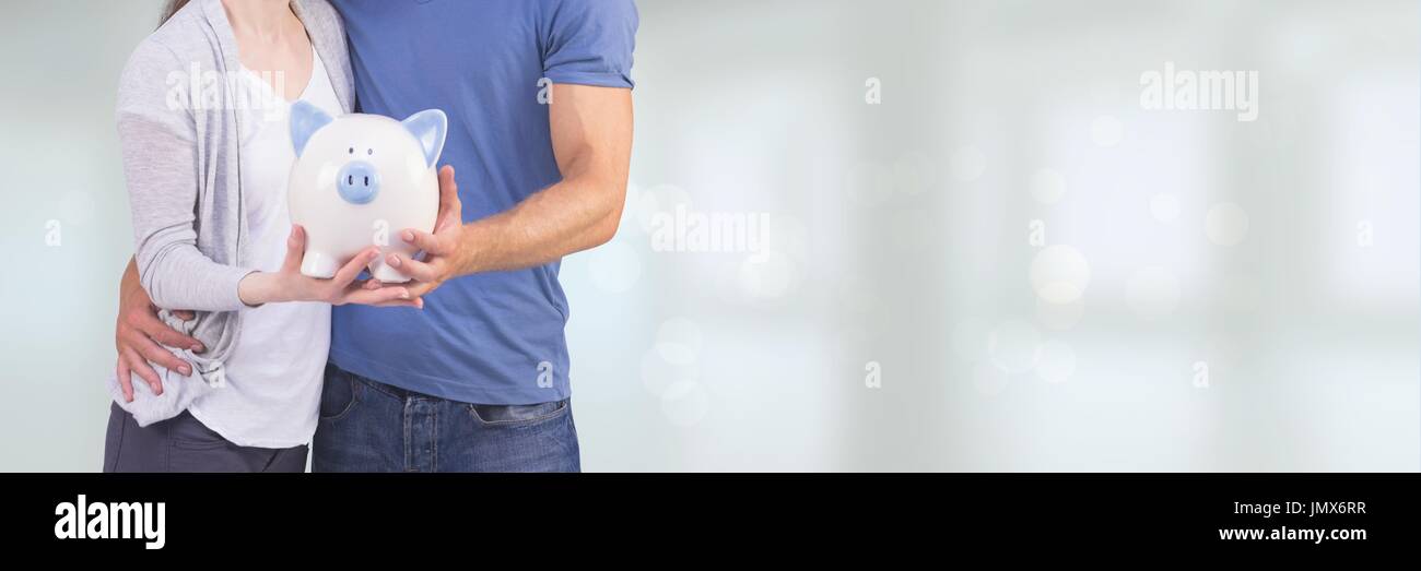 Digital composite of Couple holding a piggy bank against white ...