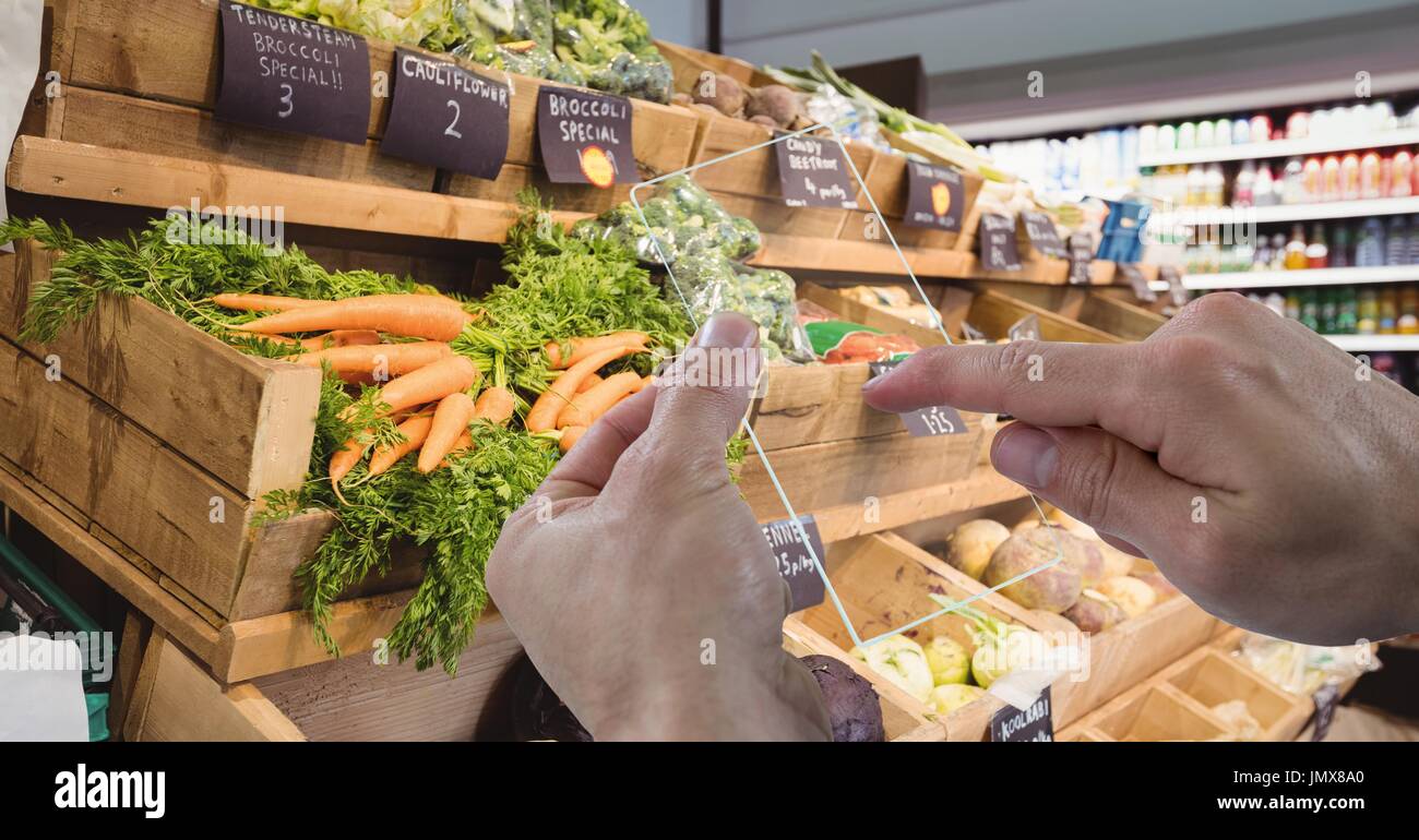 Digital composite of Cropped hand photographing vegetables through