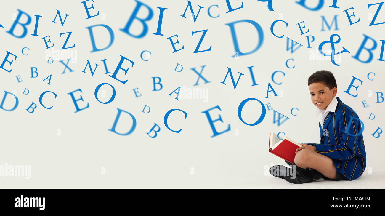 letters against schoolboy reading book on white background Stock Photo