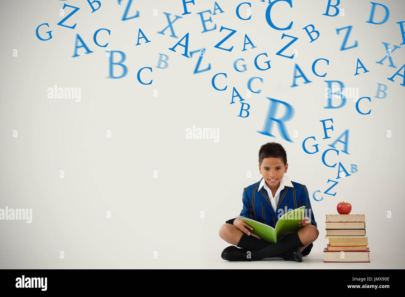 letters against schoolboy studying against white background Stock Photo