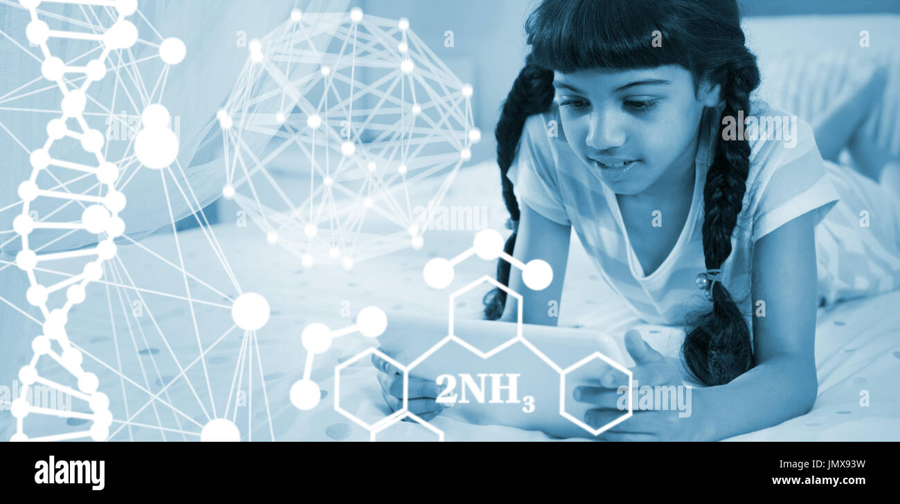 Composite image of molecular structure against girl using tablet while lying on bed at home Stock Photo