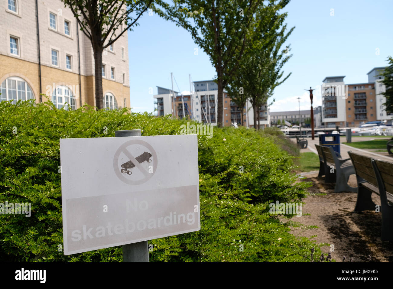 July 2017 - Old sun bleached and faded sign for No Skate boarding amongst the residential apartments and flats at Portishead Marina Stock Photo