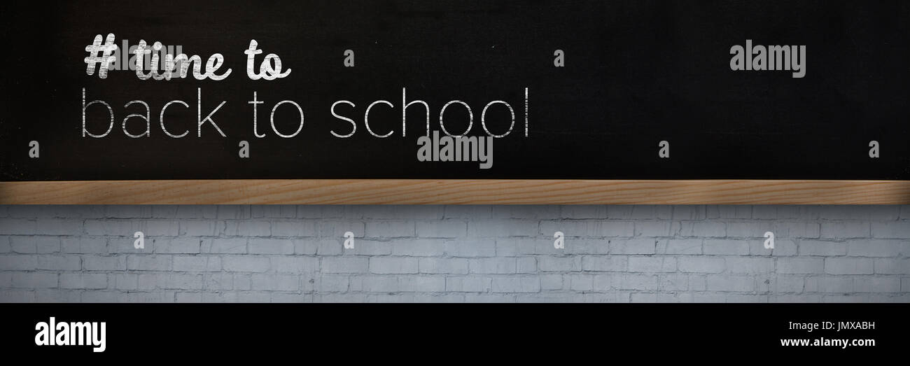 Back to school text with hashtag against blackboard on wall Stock Photo