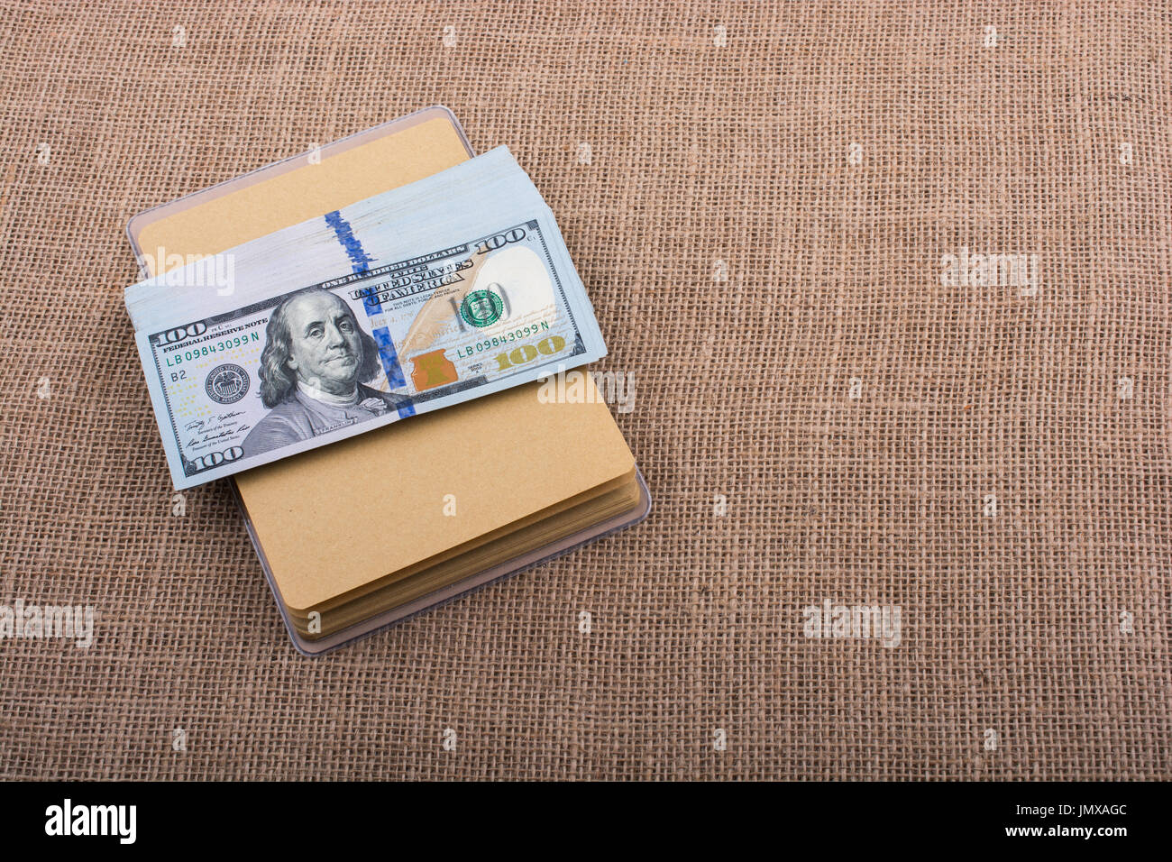 Banknote bundle of US dollar placed on a linen canvas Stock Photo - Alamy