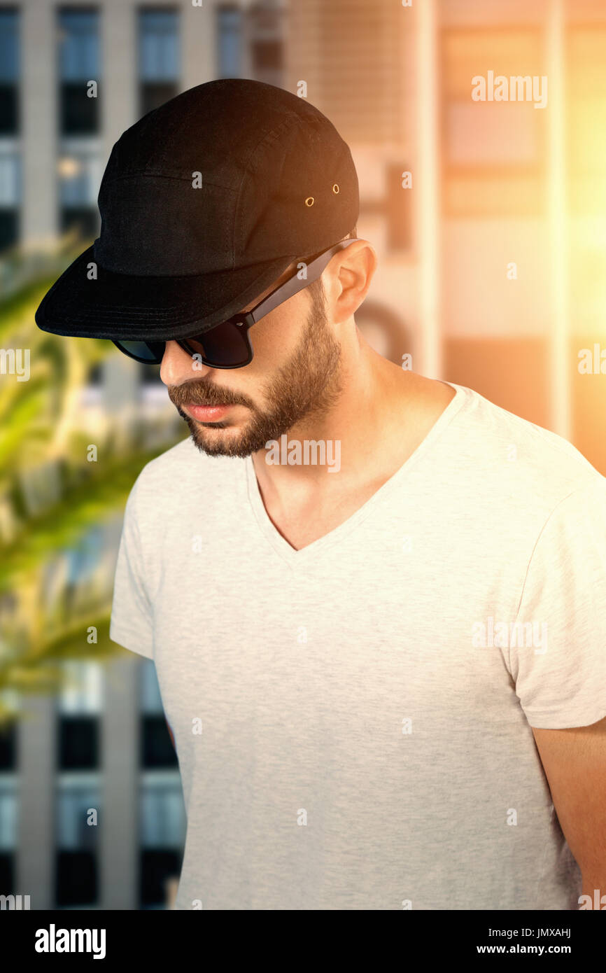 Model wearing black cap and sunglasses against front side of hotel Stock Photo Alamy