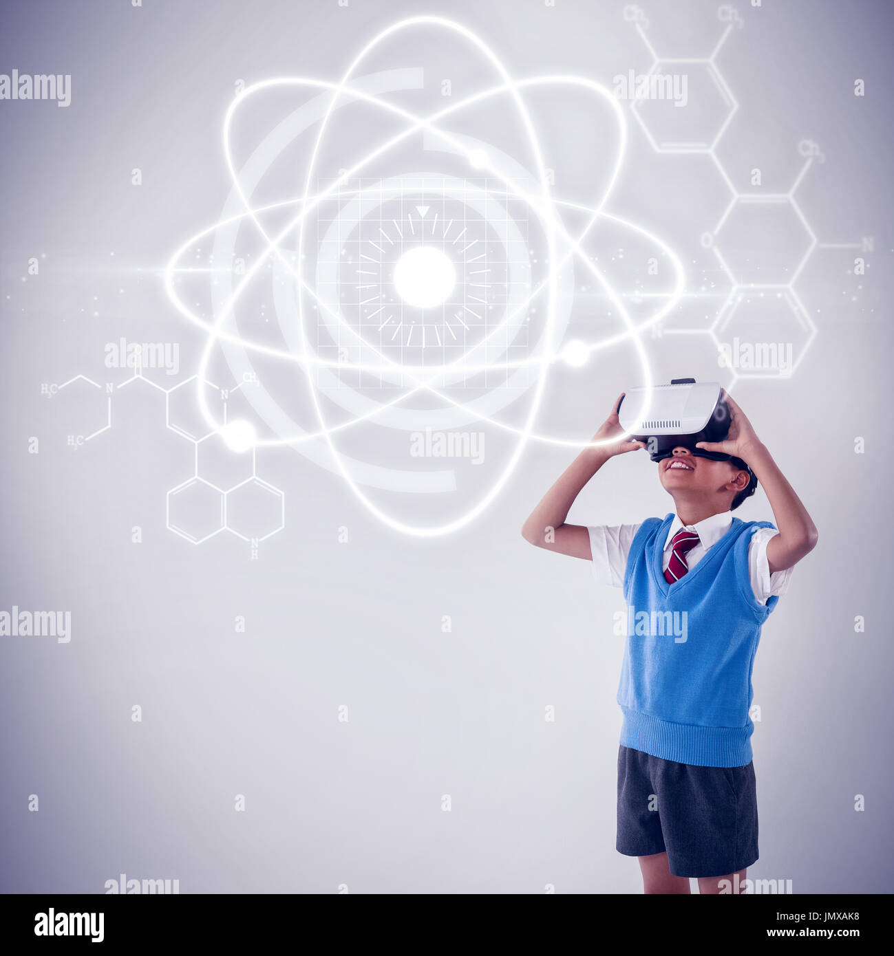 Atomic structure against black background against schoolboy using virtual reality headset Stock Photo