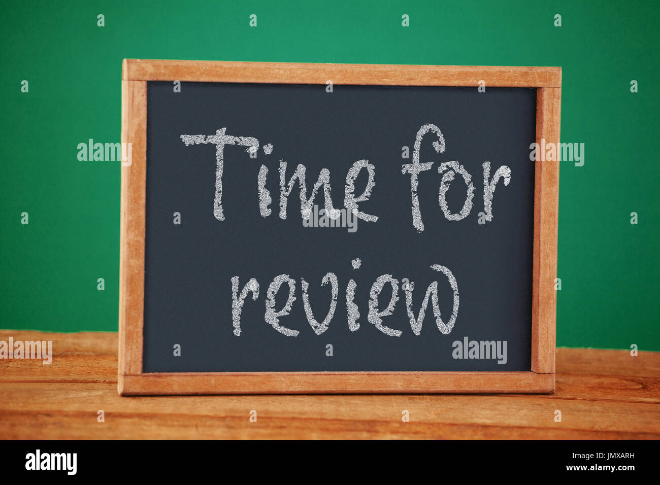 Review Empty Time for review text on white background against empty blackboard on ...