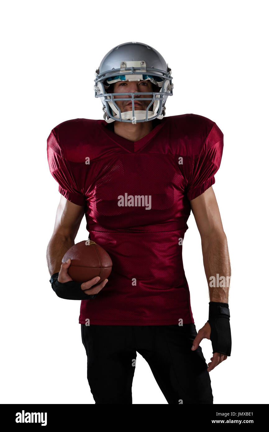 Composite image of portrait of rugby player wearing shoulder pads and  holding helmet Stock Photo - Alamy