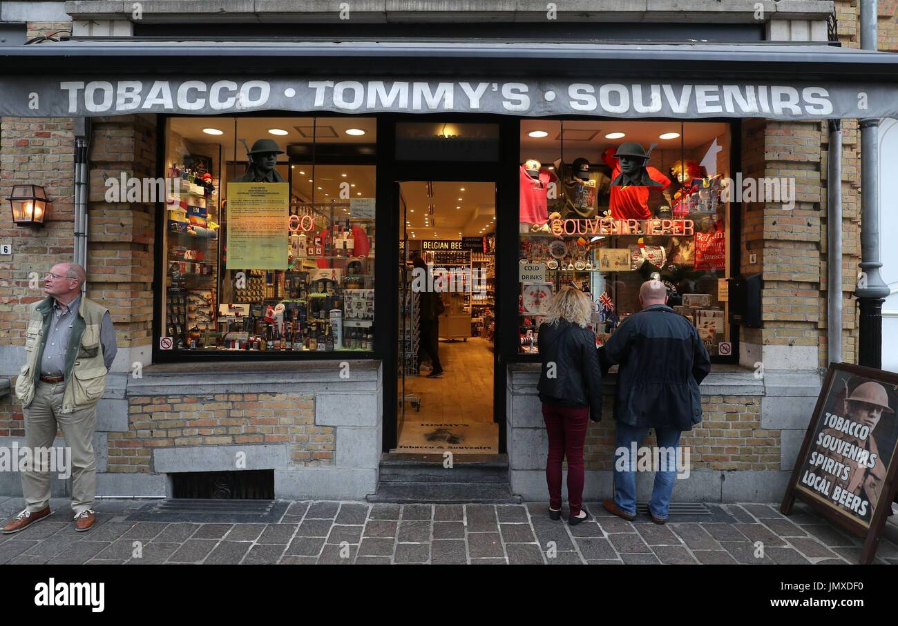 A couple look inside the window of a souvenir shop in Ypres, ahead of