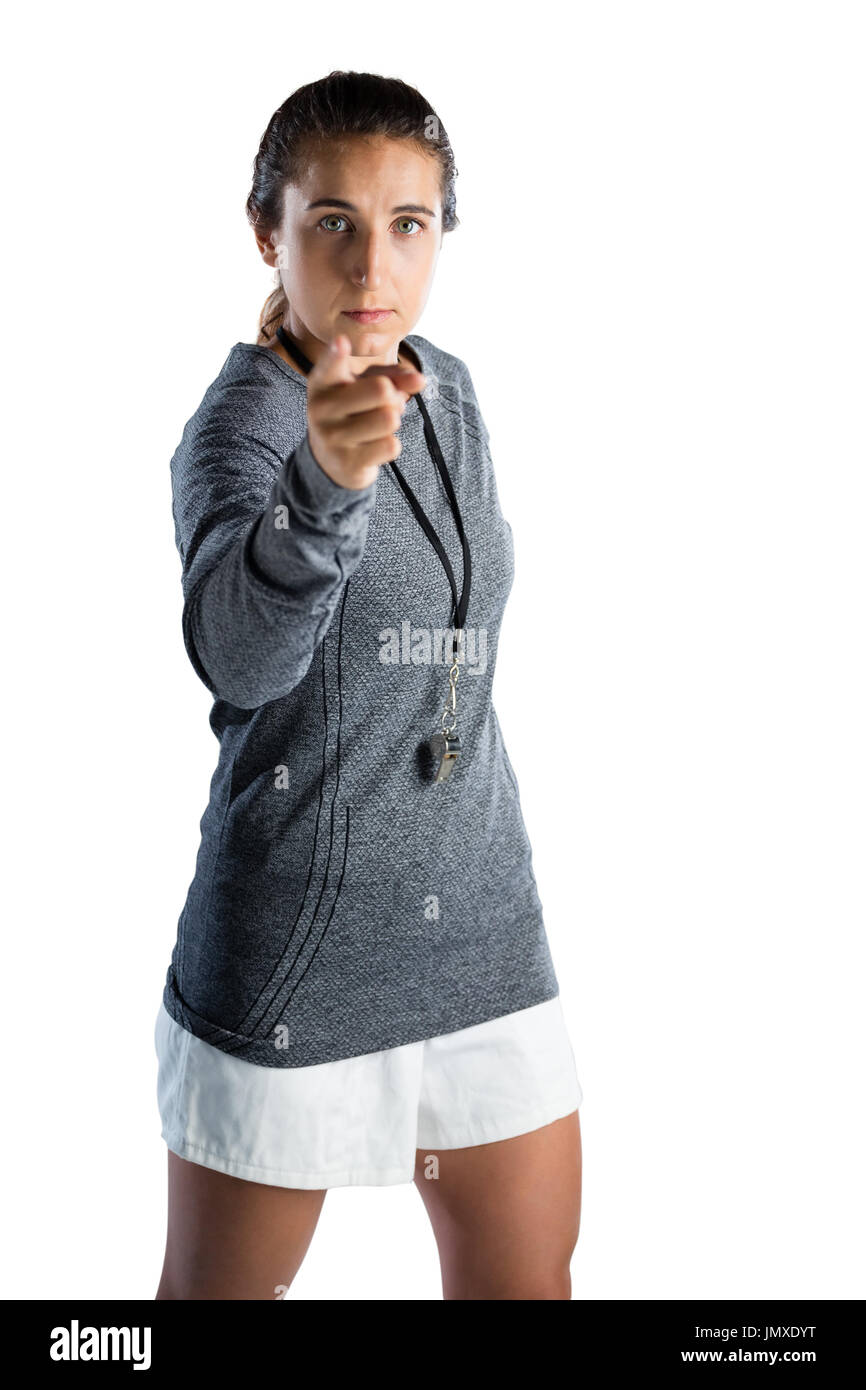 Portrait of female rugby coach pointing while standing against white background Stock Photo