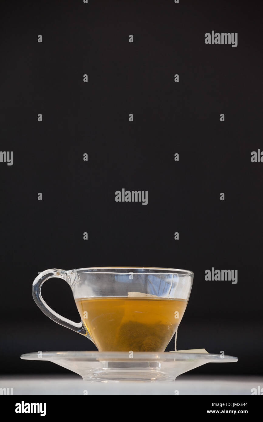 Green tea with tea bag in cup against white background Stock Photo Alamy