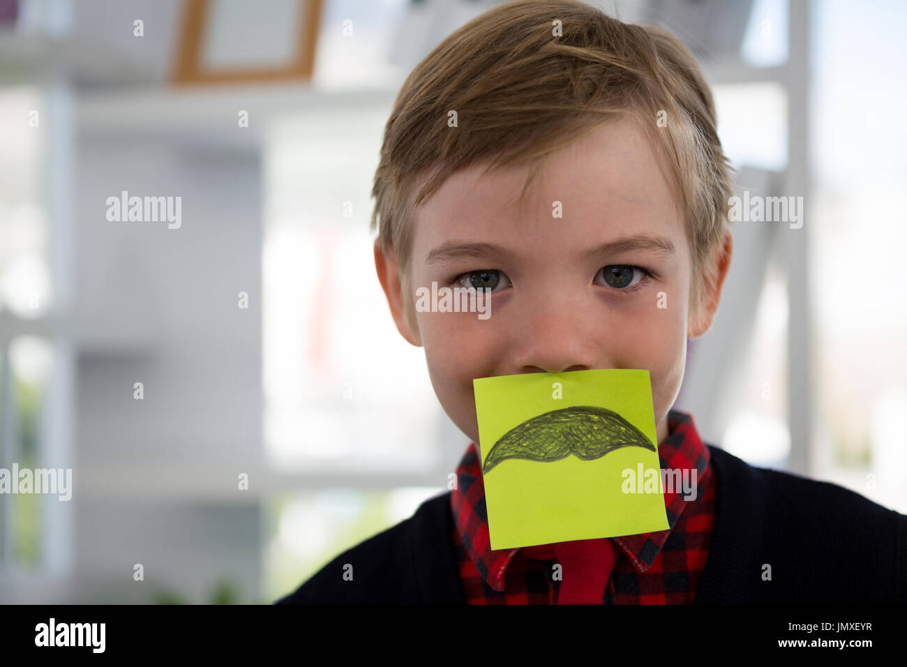 Boy as business executive sleeping in office Stock Photo