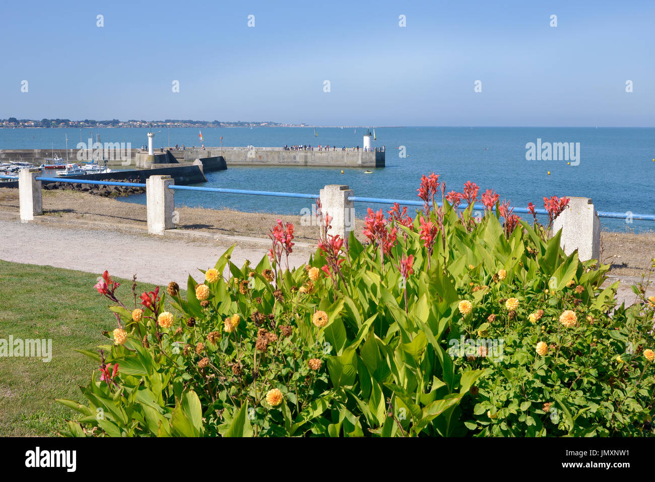 Port of Saint-Michel-Chef-Chef with the red canna flowers, in the Loire-Atlantique department in western France. Stock Photo