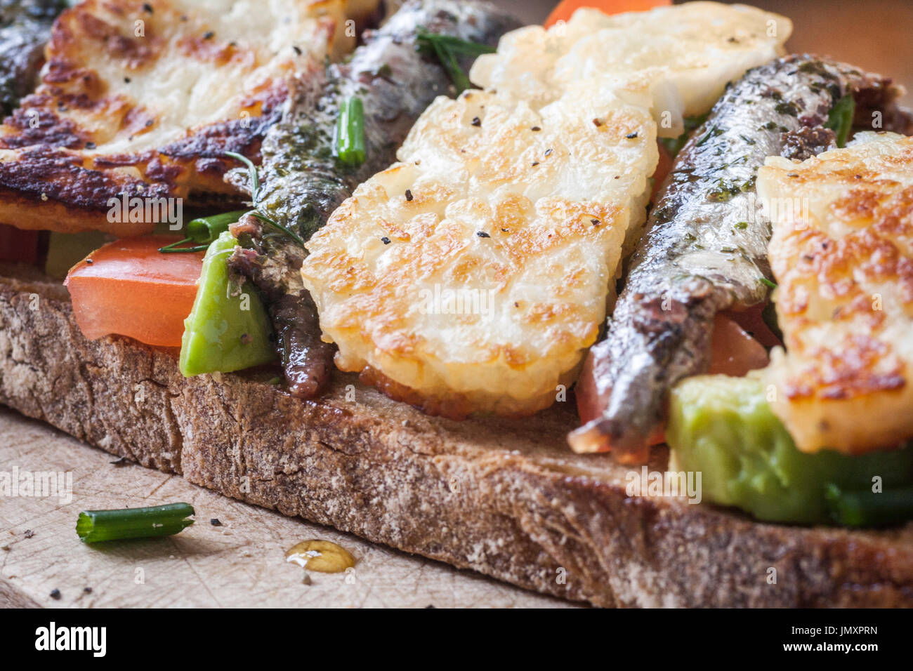Toasted sourdough bread with Tomato, Avocado, and grilled Halloumi
