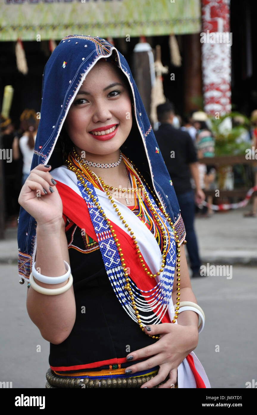 KOTA KINABALU, MALAYSIA - MAY 30, 2015: Smiling Kadazan Dusun girl wearing colorful traditional costume during Sabah Harvest festival in Kota Kinabalu Stock Photo