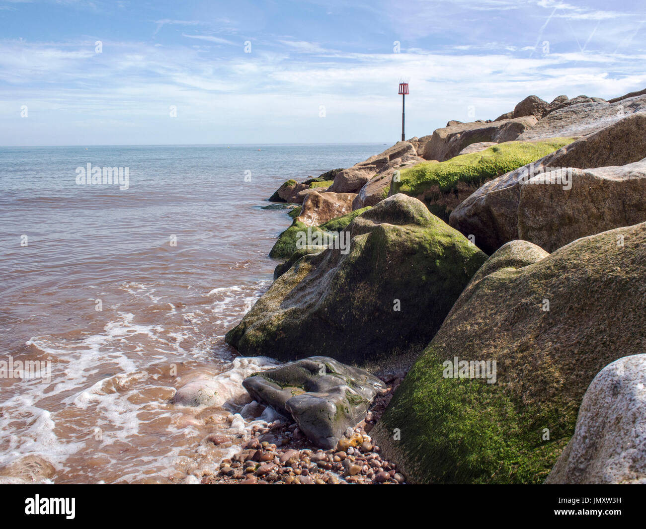 Rock armour groyne protecting the beach at Sidmouth, Devon Stock Photo