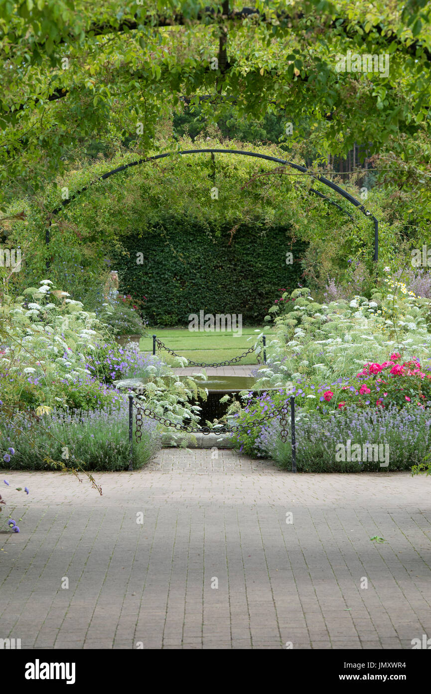 Cottage garden and Water feature and archways at RHS Wisley Gardens, Surrey, UK Stock Photo