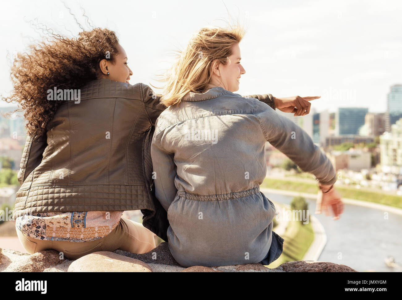 Middle Eastern girl showing to her friends the city skyline view concept Stock Photo