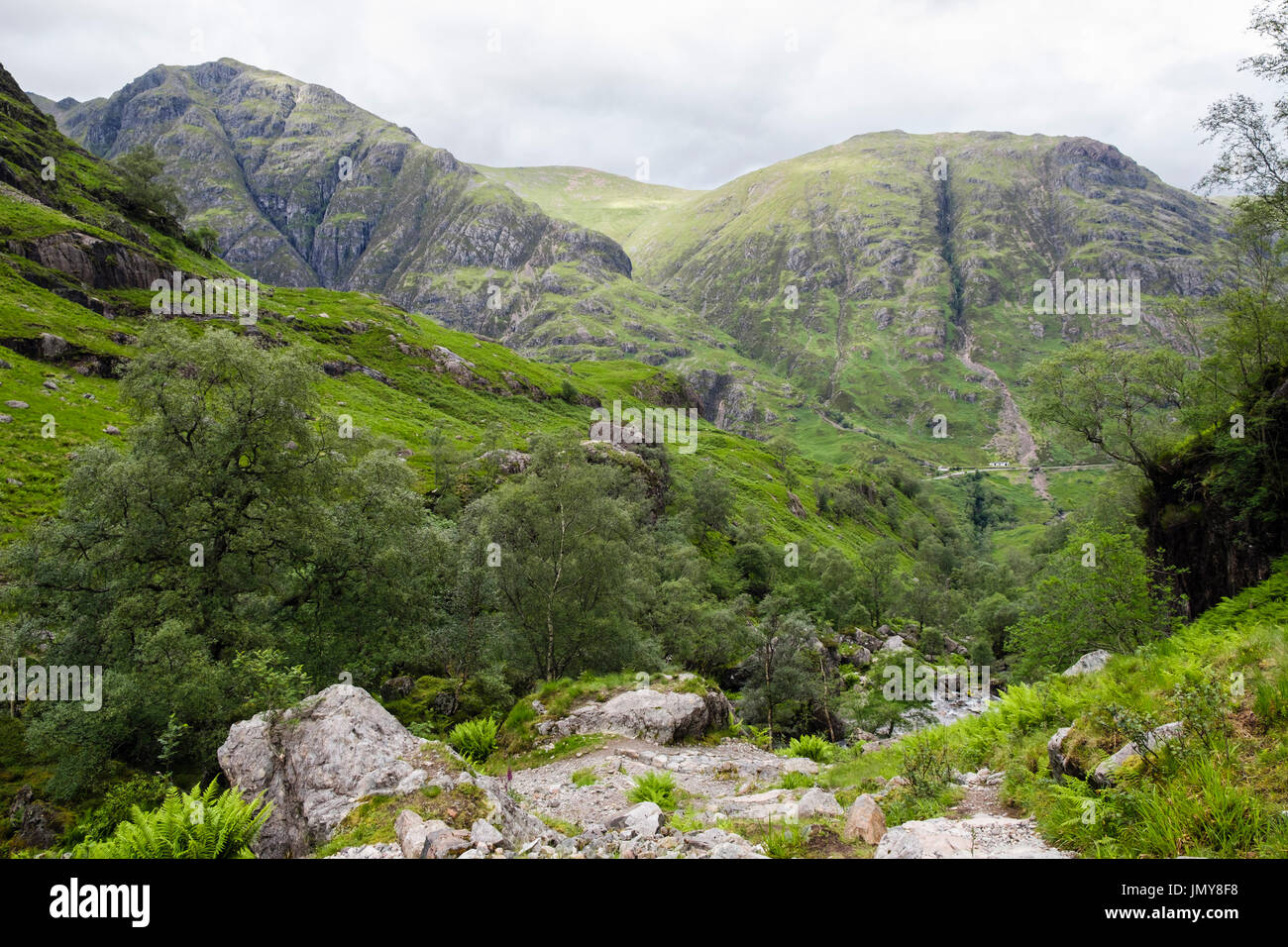 View down Hidden or Lost Valley (Coire Gabhail) to Glen Coe pass and Am Bodach mountain (left). Glencoe, Lachabar, Highland, Scotland, UK Stock Photo